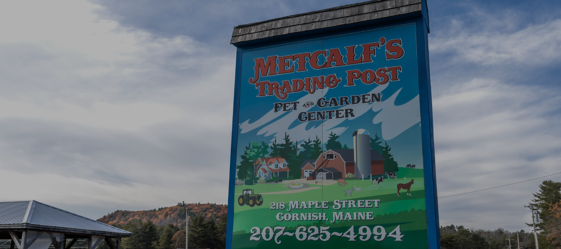 Metcalf's Trading Post storefront sign on a clear day.